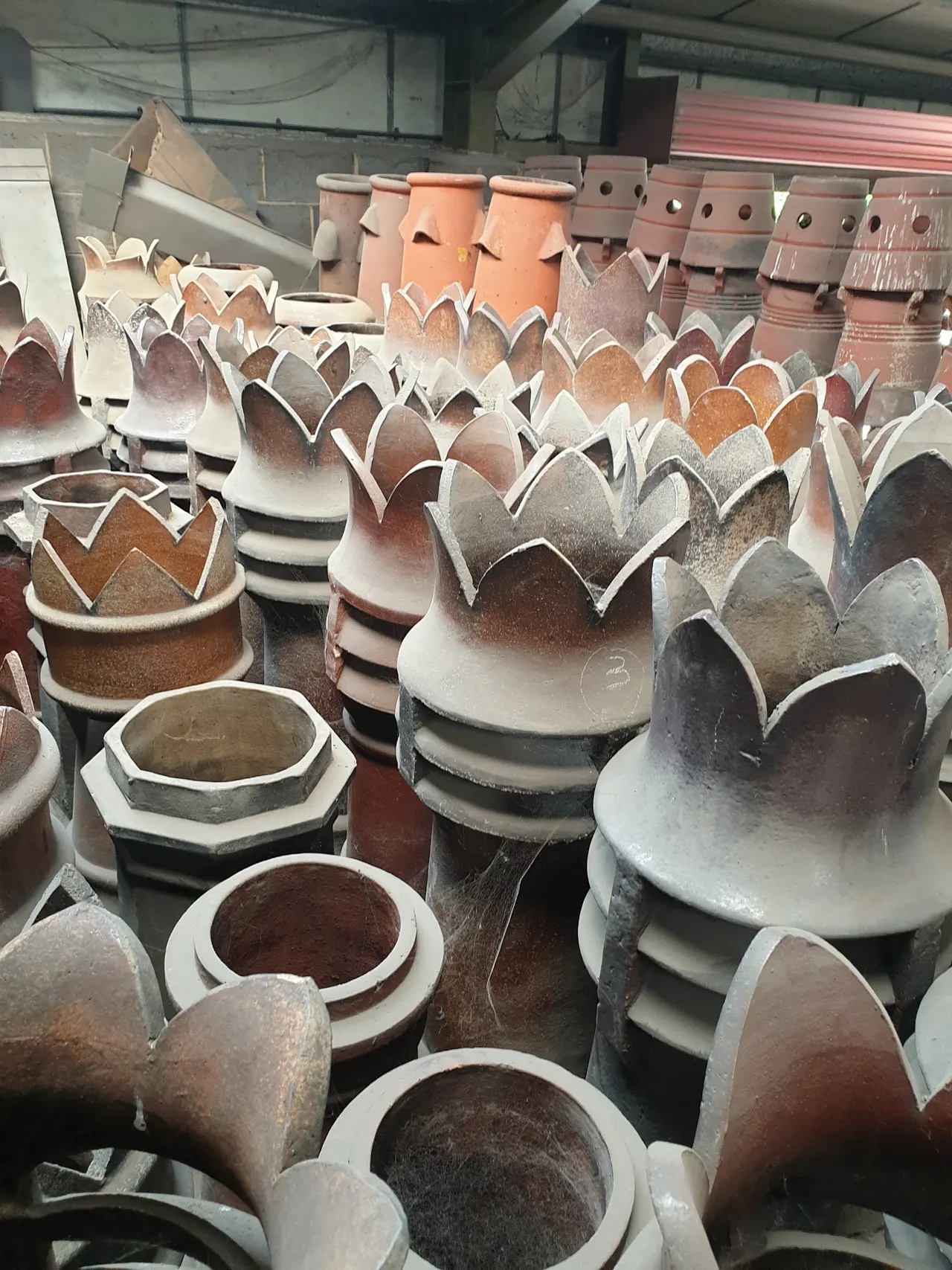 A selection of reclaimed crown top chimney pots in the yard