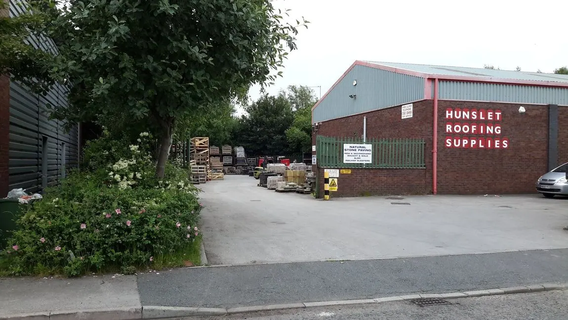 The signed Hunslet Roofing Supplies yard on Waterside Road in Leeds